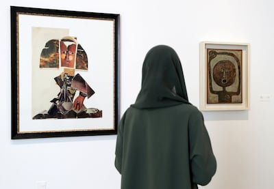 This 1963 painting by Andre Elbaz called Ladies in Waiting, left, and the 1961 painting by Belkahia, called Cuba Si, are part of the exhibition. Chris Whiteoak / The National