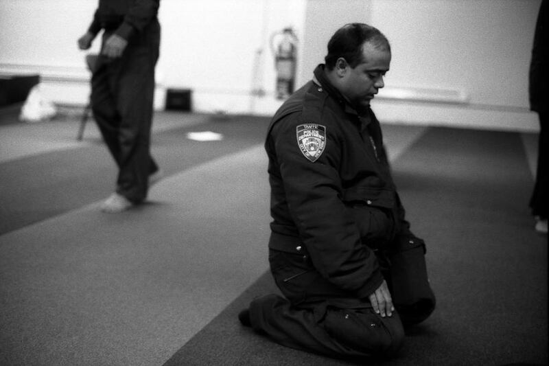 A police officer prays in New York.