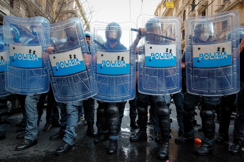 Police officers face demonstrators protesting in Naples. Environment and energy ministers from the Group of 20 industrialised countries are meeting in Naples ahead of November's crucial UN climate change conference.