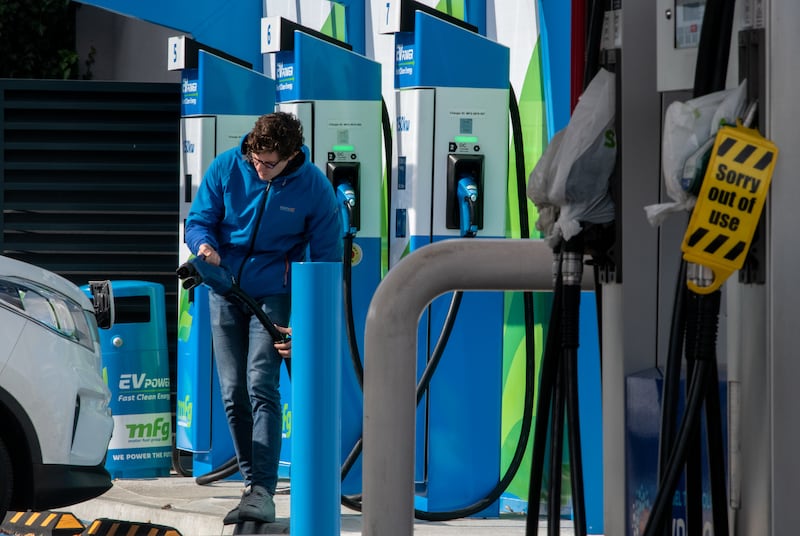 A driver plugs in his electric vehicle at a Motor Fuel Group station in the UK, which will host the Cop26 summit in November. Getty Images