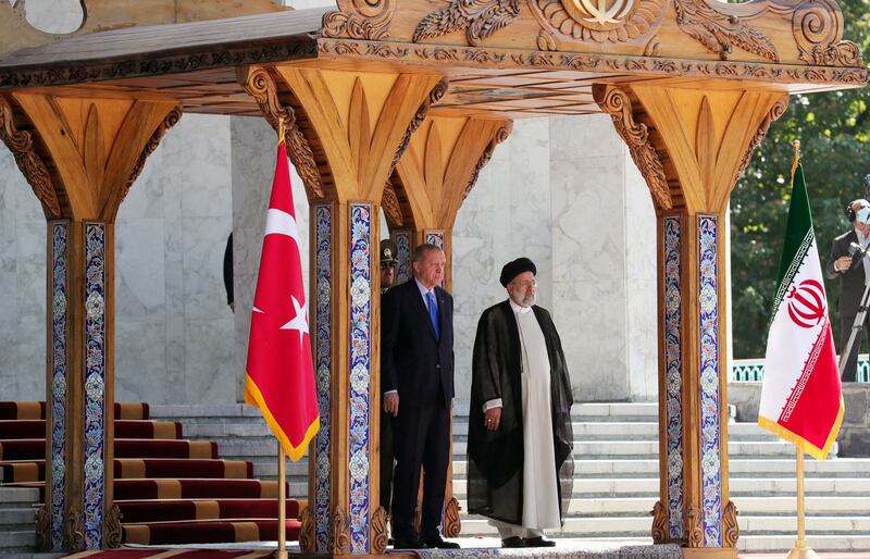 Mr Erdogan and Mr Raisi attend a welcoming ceremony in the Iranian capital. Reuters