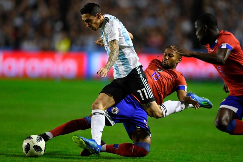 Argentina's Angel di Maria is tackled by Haiti's Mikael Cantave. Eitan Abramovich / AFP