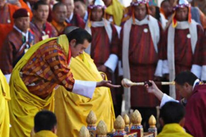 The new king of Bhutan, Jigme Khesar Namgyel Wangchuck (left) takes part in a religious ceremony moments before his coronation in Thimphu.
