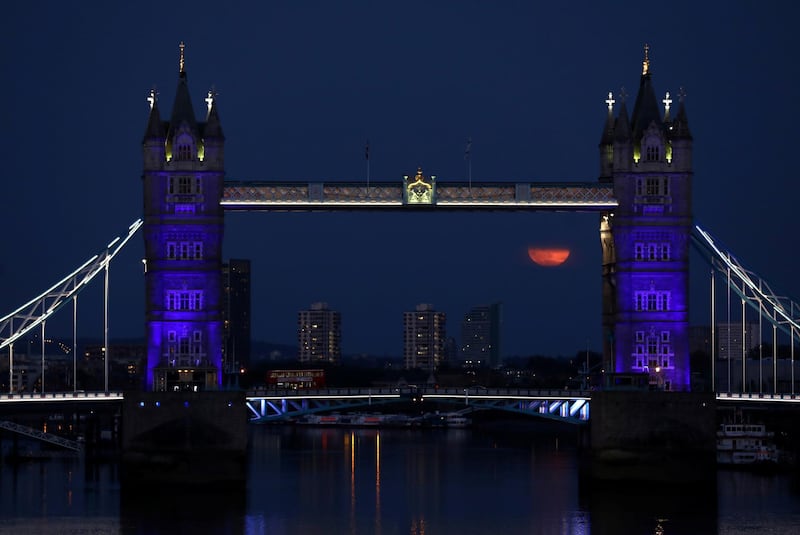 The full Moon is seen next to Tower Bridge, London, Britain. Reuters