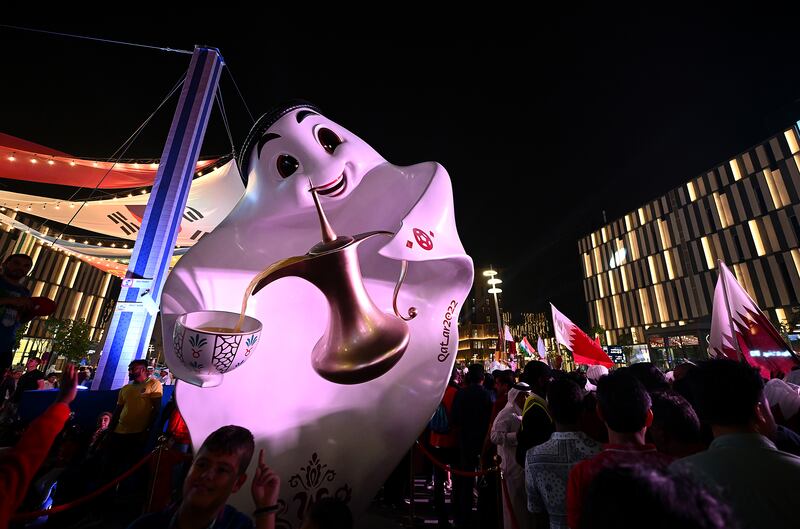 Football fans meet La'eeb, the Qatar World Cup mascot, at the Lusail Boulevard fan area. La'eeb is an Arabic word for a hotshot footballer. Getty Images