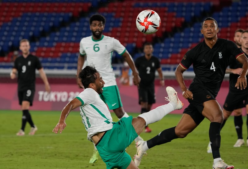 Saudi Arabia's Khalid Al Ghannam clears the ball against Germany during a men's football match in Yokohama. Saudi Arabia lost 2-3 to bow out of the competition from Group D.