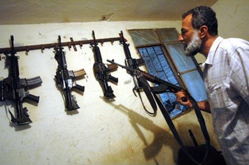 A Fatah commander shows off weapons at his home in the Ain el Hilweh refugee camp.