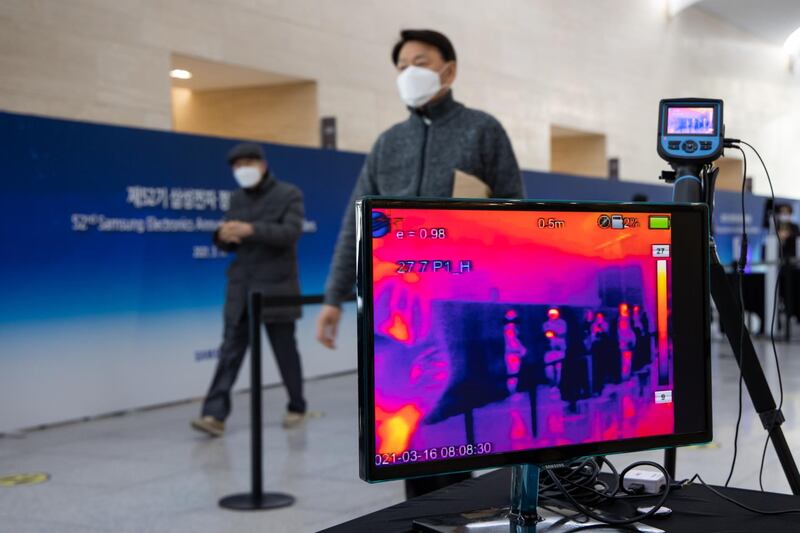 An attendee walks past a temperature screening checkpoint at the Samsung Electronics Co. annual general meeting held at the Suwon Convention Center in Suwon, South Korea. Huawei Technologies Co. will begin charging mobile giants like Samsung a "reasonable" fee for access to its trove of wireless 5G patents, potentially creating a lucrative revenue source by showcasing its global lead in next-generation networking. Bloomberg