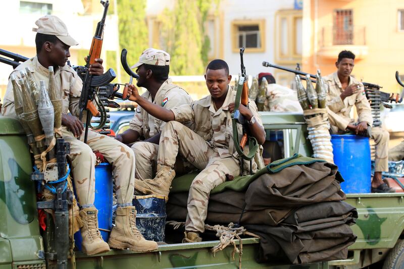 Sudanese soldiers secure the area as Sudan's ousted president Omar Al Bashir leaves the office of the anti-corruption prosecutor in Khartoum, Sudan, on June 16, 2019. Reuters