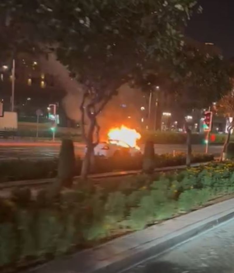 Dubai fire crews arrived to extinguish the flames, which were concentrated under the car's bonnet. Photo: Screengrab from video