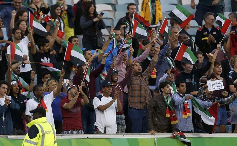 UAE football fans cheer on their side during the Emiratis' 4-1 win over Qatar on Sunday at the Asian Cup in Australia. Tim Wimborne / Reuters