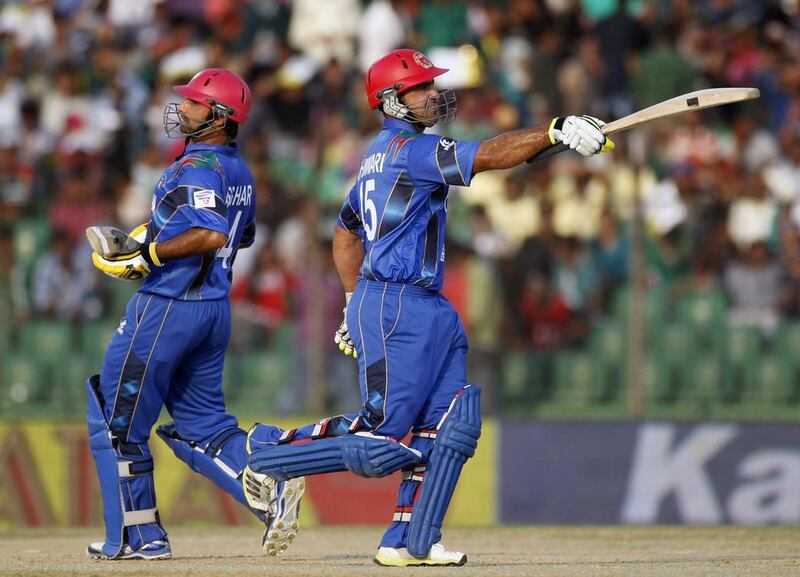 Afghanistan’s Samiullah Shenwari celebrates after scoring a half century that gave the team a vital edge in posting a target Bangladesh failed to surpass on Saturday, March 1, 2014. Andrew Biraj / Reuters