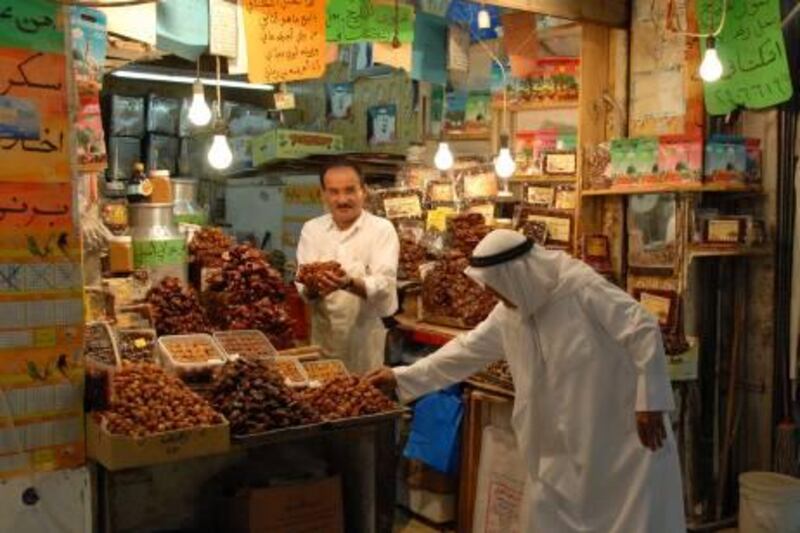 An old Kuwaiti man tries dates at the old Mubarkiya Souq in Kuwait City on Feb. 20, 2011. (Photo: Gustavo Ferrari for The National)