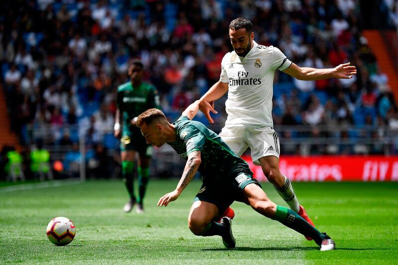 Real Madrid defender Dani Carvajal, right, challenges Real Betis forward Loren Moron. AFP