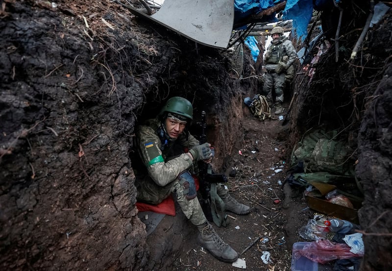Ukrainian servicemen rest at their positions after a battle near the front-line city of Bakhmut. Reuters