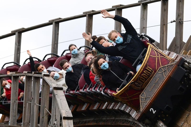 Visitors ride on a rollercoaster at Europa Park in Rust, western Germany, on the re-opening day of the park following the lifting of coronavirus restrictions. AFP