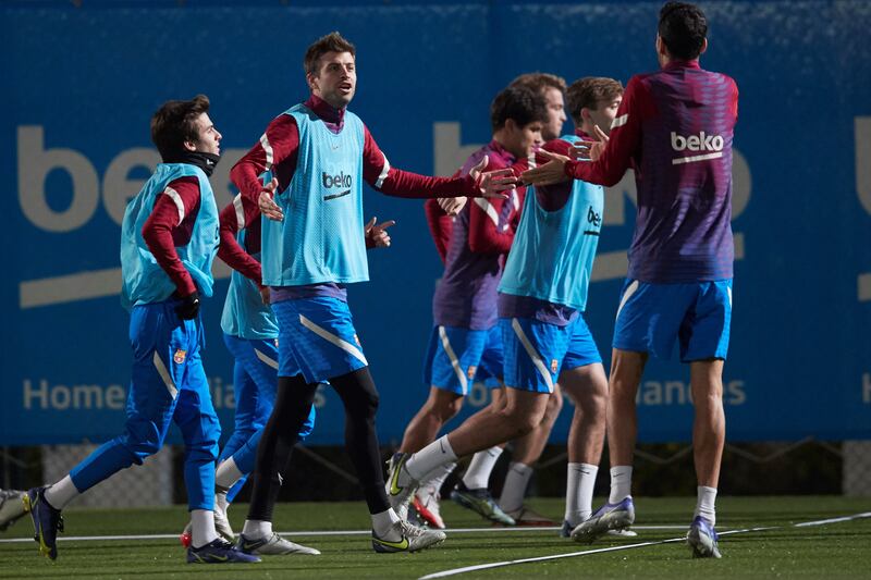 Barcelona defender Gerard Pique chats with Sergio Busquets. EPA