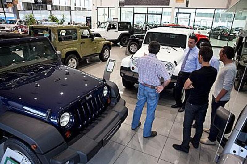 Potential customers check out Jeep SUVs as they shop around in Abu Dhabi. Consumer borrowing has surged recently. Silvia Razgova / The National