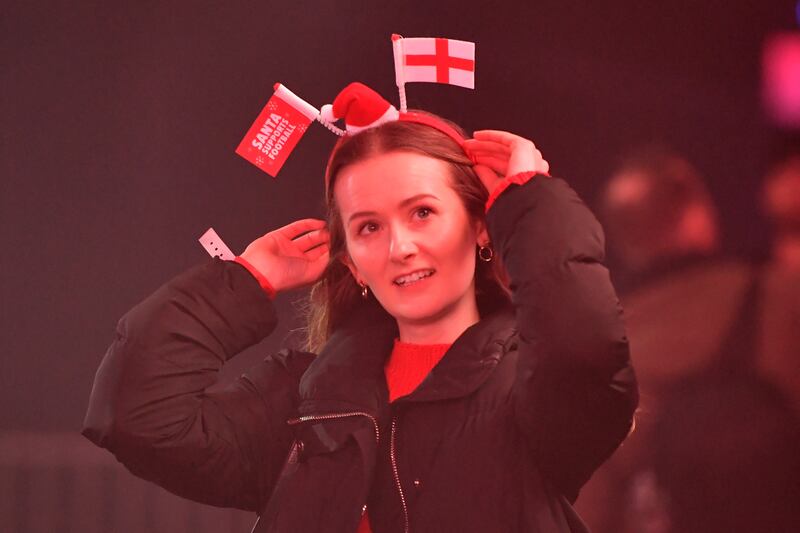 A woman wears an England-themed headband as supporters gather to watch the World Cup in Manchester. Getty Images