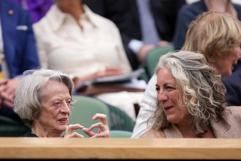 Actress Dame Maggie Smith sits with her daughter-in-law Suki Stephens in the royal box. AP
