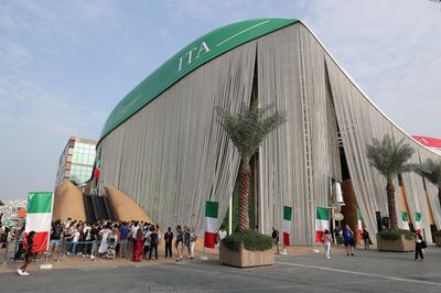 Visitors on Monday outside the Italy pavilion, which was closed for a short period to repair rain damage. Pawan Singh / The National