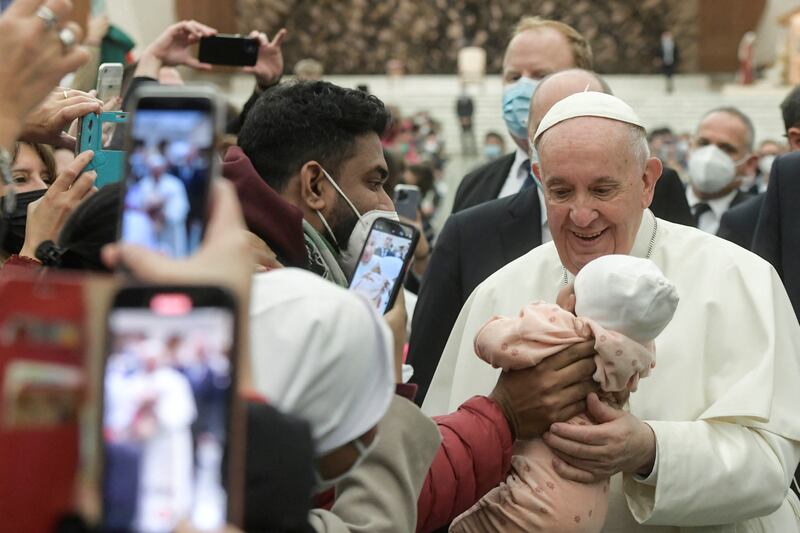 Pope Francis meets a baby at the Vatican.  Reuters