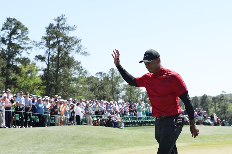 Tiger Woods waves to the crowd on the 18th green after finishing his round during the final round of the Masters at Augusta National Golf Club on April 10, 2022. AFP
