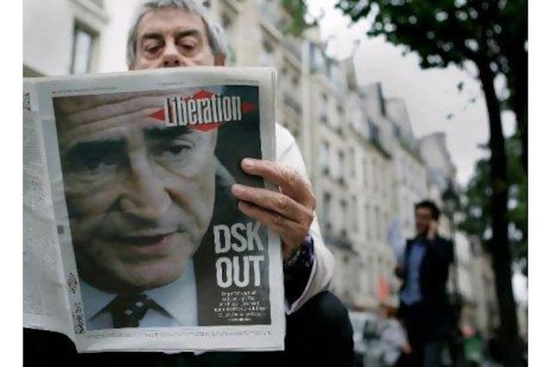 A Parisian reads a newspaper featuring an account of the tribulations of "disgraced" chief of the International Monetary Fund. A reader asks if he was treated fairly by the US legal system and media. Franck Prevel / Getty Image