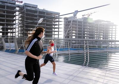 DUBAI, UNITED ARAB EMIRATES. 13 MAY 2020. 
Triathlete Afra Al Majar excercises with Asma Al Janahi by Dubai Canal. Asma is a commitee member of the UAE Triathlon Association. 
(Photo: Reem Mohammed/The National)

Reporter:
Section: