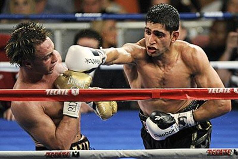 Amir Khan, right, showed a dominant performance to beat local favourite Paulie Malignaggi at Madison Square Garden, New York.