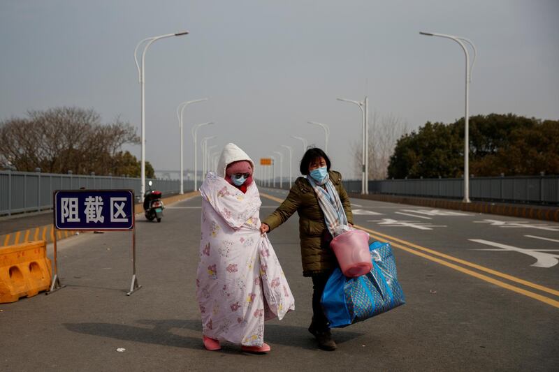 A leukaemia patient and her mother coming from Hubei province cross a checkpoint at the Jiujiang Yangtze River Bridge in Jiujiang, Jiangxi province, China, as the country is hit by an outbreak of a new coronavirus. Reuters