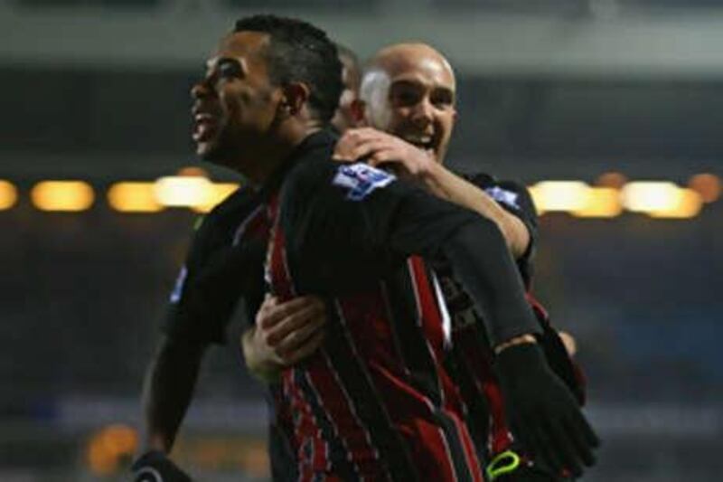 Joey Ireland, right, congratulates the Brazil striker Robinho after his late equalliser ensured Manchester City left Ewood Park with a point against Blackburn.