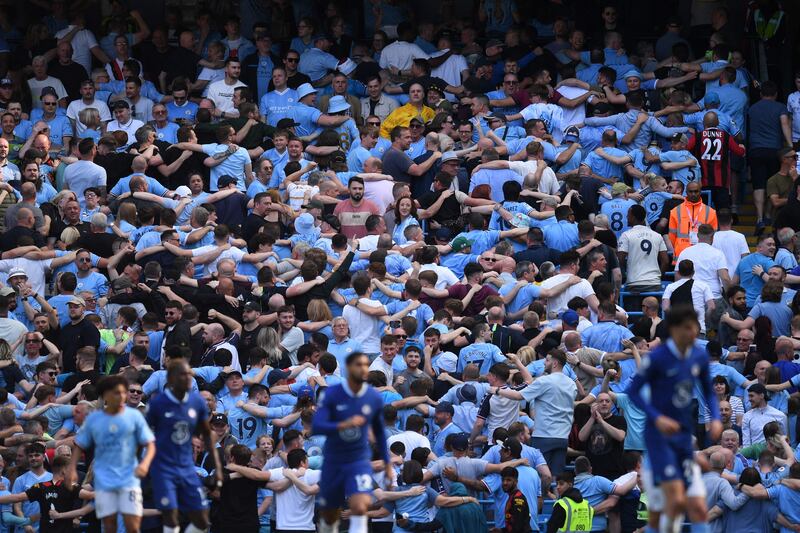 City fans do 'the Poznan' celebration during the match. AFP