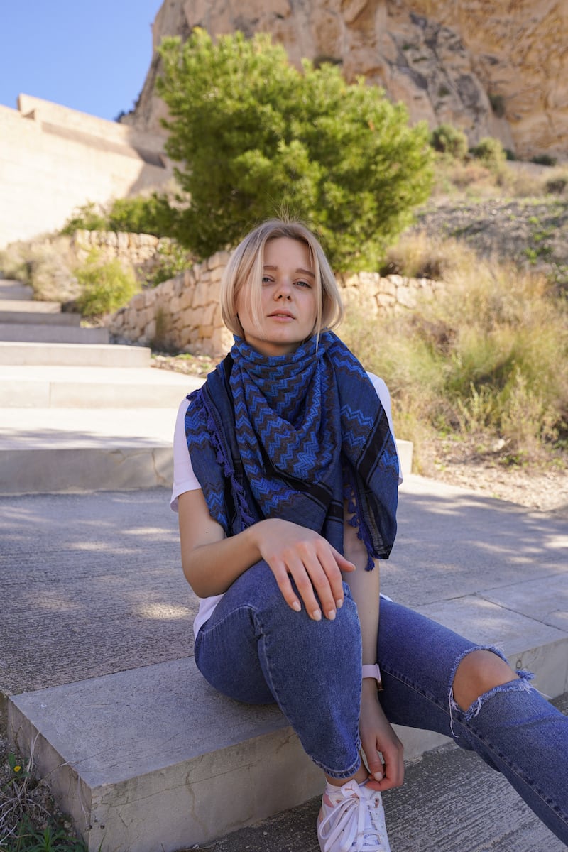 A model shows off a deep blue scarf. Photo: HirbawiUSA
