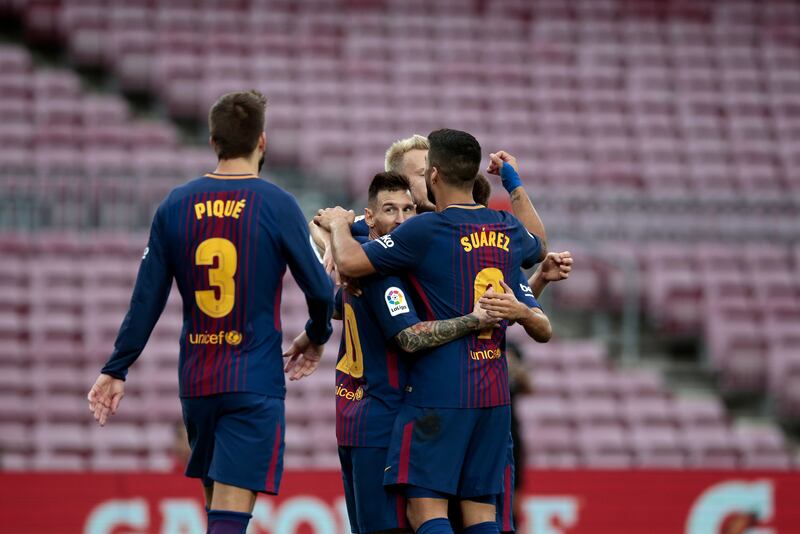 Barcelona's Lionel Messi , center, celabrates with teammates after scoring his side's second goal during the Spanish La Liga soccer match between Barcelona and Las Palmas at the Camp Nou stadium in Barcelona, Spain, Sunday, Oct. 1, 2017. Barcelona's Spanish league game against Las Palmas is played without fans amid the controversial referendum on Catalonia's independence. (AP Photo/Manu Fernandez)