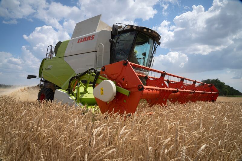 A farmer harvests his field 10 kilometres from the front line, where fierce battle continues between Ukrainian troops and Russian invaders in the Dnipropetrovsk region, Ukraine. AP