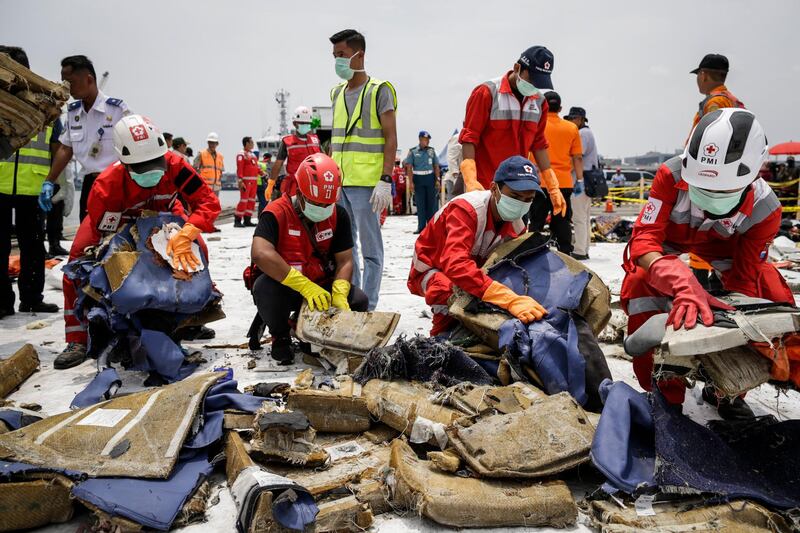 Indonesian rescuers sort recovered debris of Lion Air flight JT610 before loading onto a lorry for investigation by the National Transportation Safety Committee at Tanjung Priok port in Jakarta.  All photos by EPA