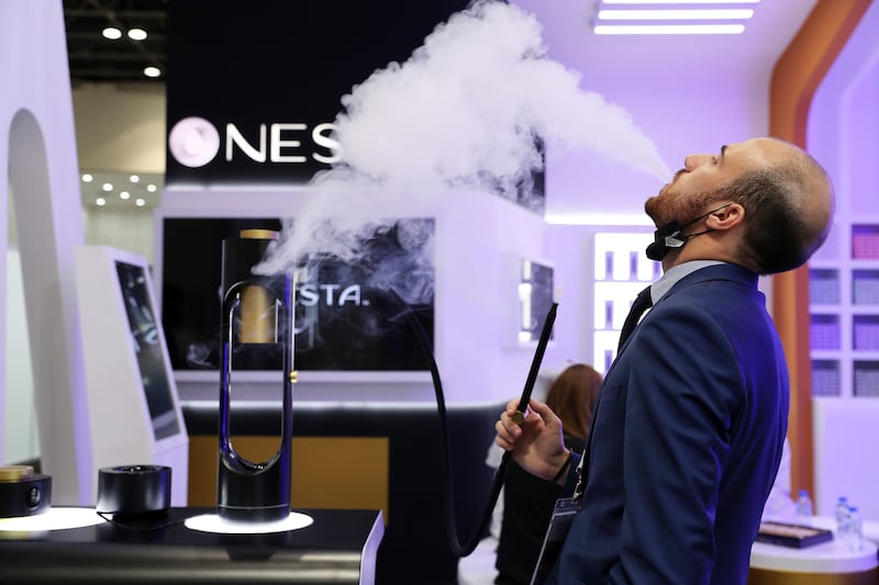 A sales representative shows how the pipe delivers nicotine via vibrations.