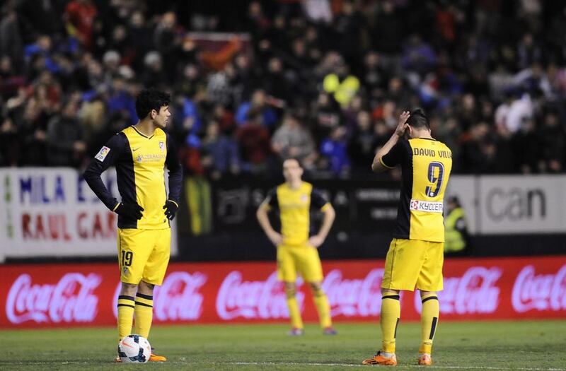 Atletico de Madrid's Diego Costa, left, and David Villa react during their 3-0 Spanish Primera Liga loss at Osasuna on February 23, 2014. Alvaro Barrientos / AP Photo