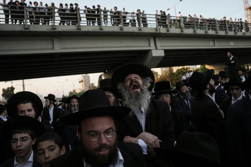 Ultra-Orthodox Jewish men block a road in protest against army recruitment regulations in Bnei Brak, Israel. AP