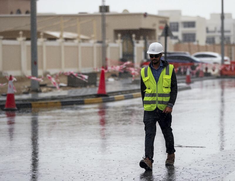 Abu Dhabi, U.A.E., February 2, 2019.   Sudden downpour at Khalifa City, Abu Dhabi.  Workers walk in the rain during a sudden downpour.
Victor Besa/The National
Section:  NA
Reporter: