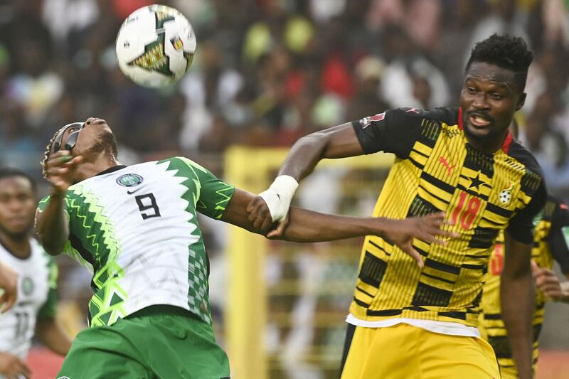 Ghana's Daniel Amartey and Victor Osimhen of Nigeria battle for the ball at the National Stadium in Abuja on March 29, 2022. AFP