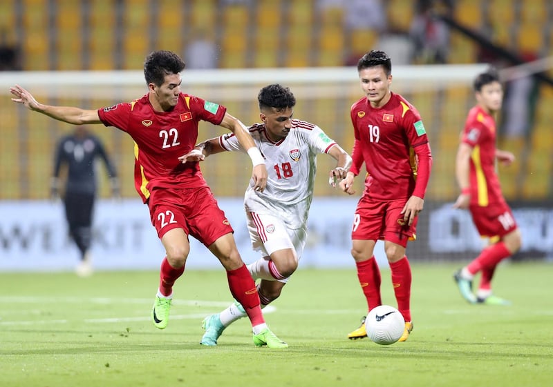 UAE's Abdullah Ramadan battles with Nguyễn Tiến Linh (L) of Vietnam during the game between the UAE and Vietnam in the World cup qualifiers at the Zabeel Stadium, Dubai on June 15th, 2021. Chris Whiteoak / The National. Reporter: John McAuley for Sport