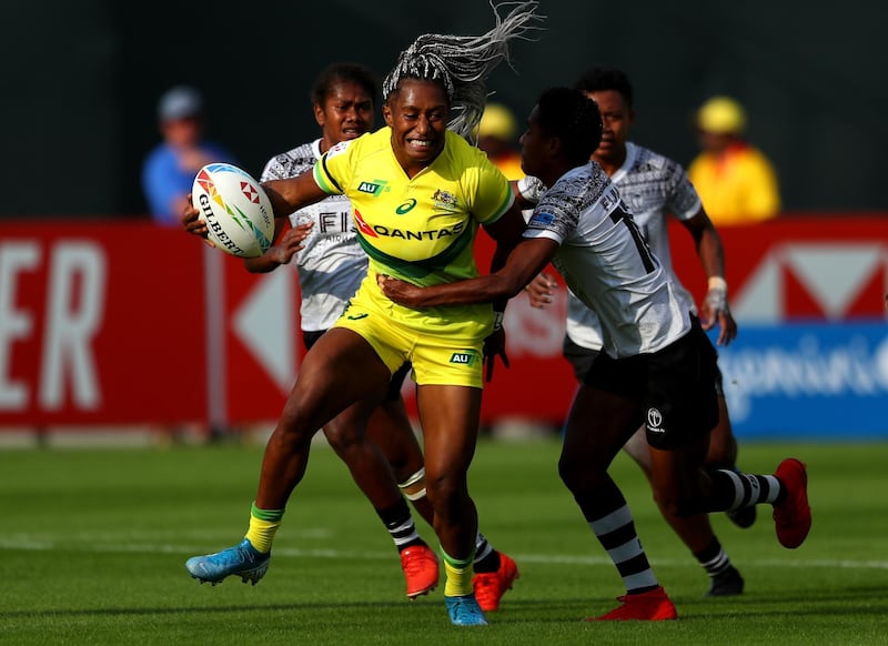 DUBAI, UNITED ARAB EMIRATES - DECEMBER 05: Ellia Green of Australia is tackled by Roela Radiniyavuni of Fiji during the match between Australia and Fiji on Day One of the HSBC World Rugby Sevens Series - Dubai at The Sevens Stadium on December 05, 2019 in Dubai, United Arab Emirates. (Photo by Francois Nel/Getty Images)