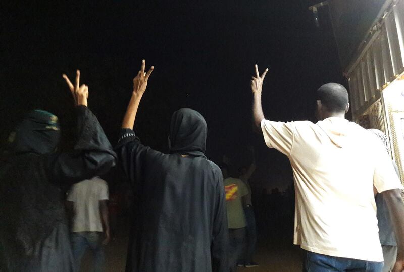 Sudanese demonstrators flash the V-sign for victory during an anti-government protest in the Haj Yousef neighbourhood of the Bahari district in the capital Khartoum on January 22, 2019. Sudanese police fired tear gas at hundreds of protesters in the capital and its twin city of Omdurman today as demonstrators staged night-time rallies against the government.
The after-dark demonstrations were the latest in more than a month of escalating protests against President Omar al-Bashir's three-decade rule.
 / AFP / STRINGER
