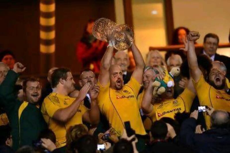 Australia captain Nathan Sharpe, centre, lifts the Cook Cup following the Wallabies’ victory over England at Twickenham.