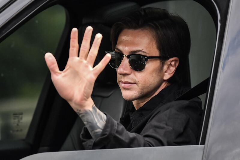 Juventus' Italian forward Federico Bernardeschi waves as he arrives in his car. AFP