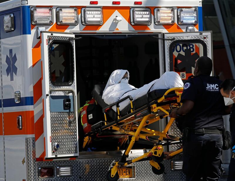 epa06999558 A passenger from Emirates Flight 203 from Dubai that landed at JFK International Airport this morning is transported on a stretcher by paramedics to an ambulance at terminal four in JFK International Airport in Queens, New York, USA, 05 September 2018. According to reports, an Airbus A380 of UAE carrier Emirates was quarantined at New York's JFK airport on 05 September 2018 after some 100 passengers aboard reported feeling ill.  EPA/PETER FOLEY