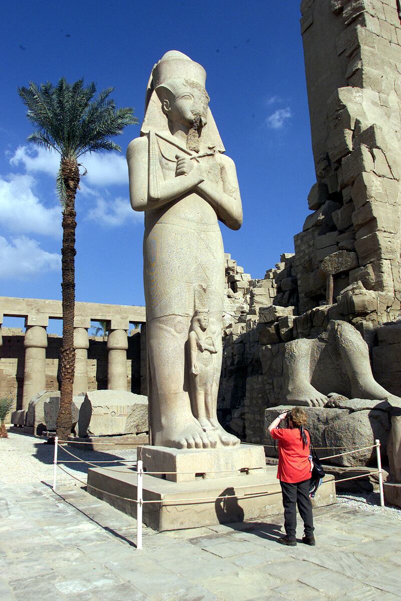 A visitor takes a picture of Pharaoh King Ramses II's statue at Karnak
temple January 13, 2002. The temple, about 4000 years old, was
renovated and reopened to the public. REUTERS/Aladin Abdel Naby

AN/CLH/