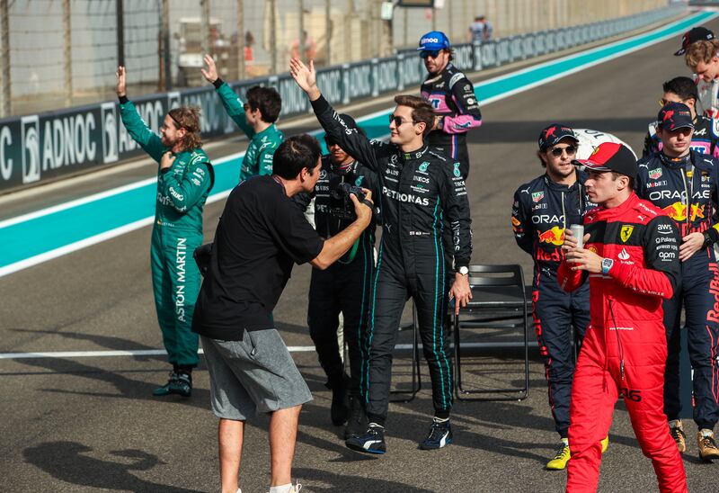 Drivers wave to the crowd at Yas Marina Circuit